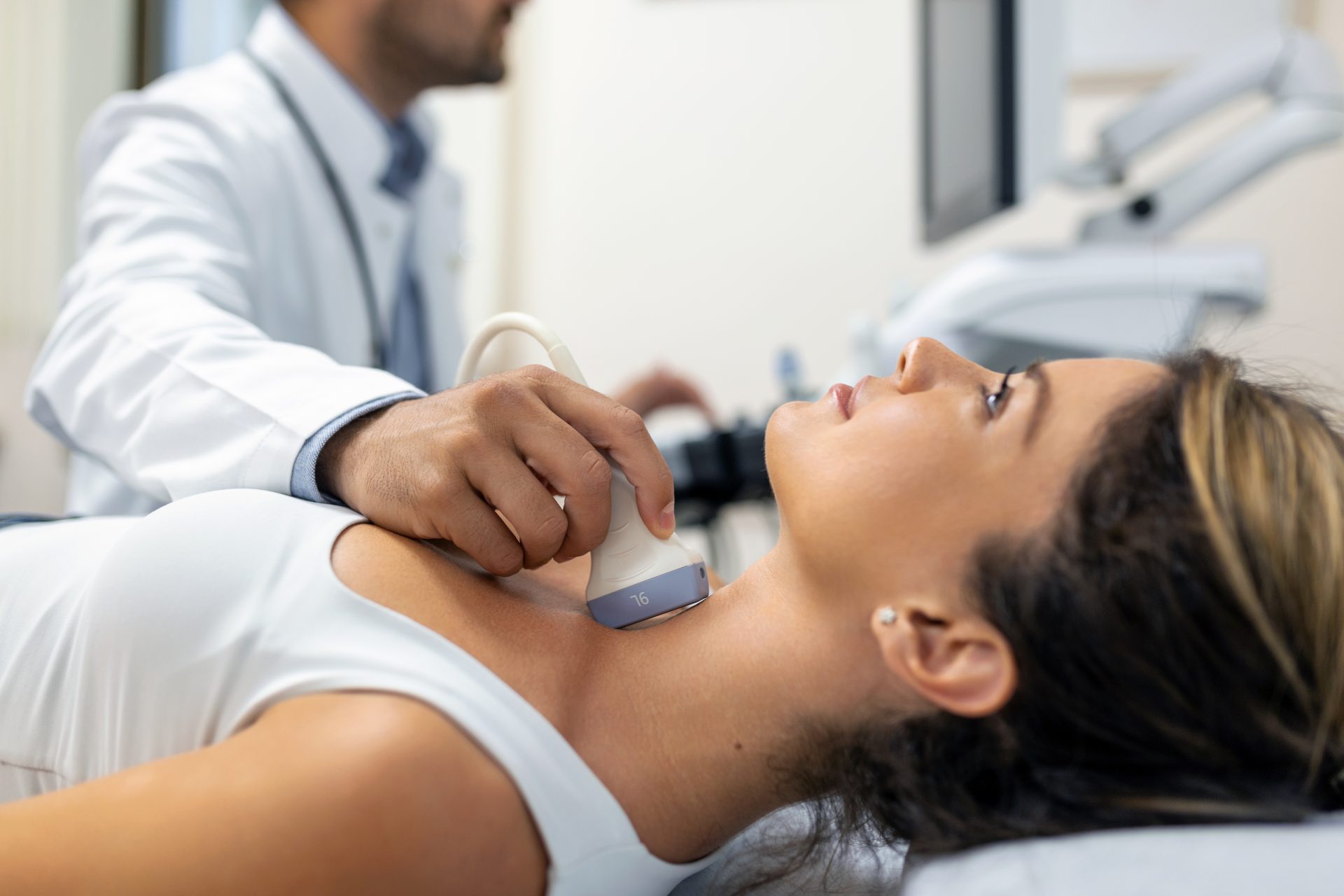 close-up-shot-young-woman-getting-her-neck-examined-by-doctor-using-ultrasound-scanner-modern-clinic